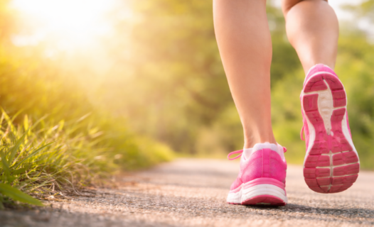 Vrouw met roze hardloopschoenen die rustig hardloopt als symbool voor herstel en opbouw na een keizersnede